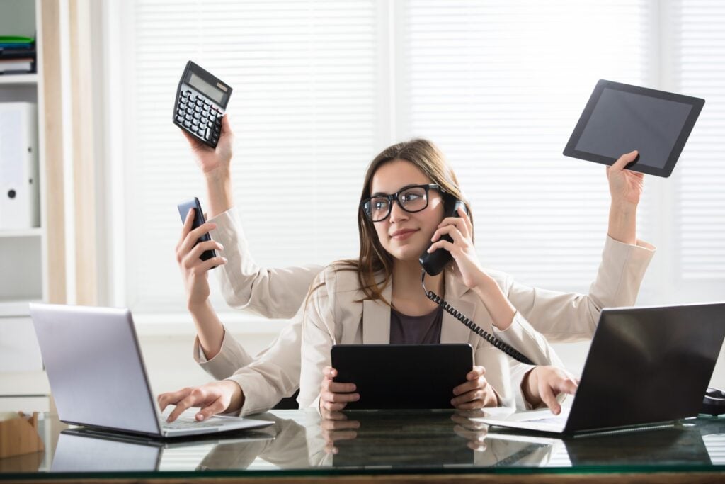 A woman is multitasking in her office